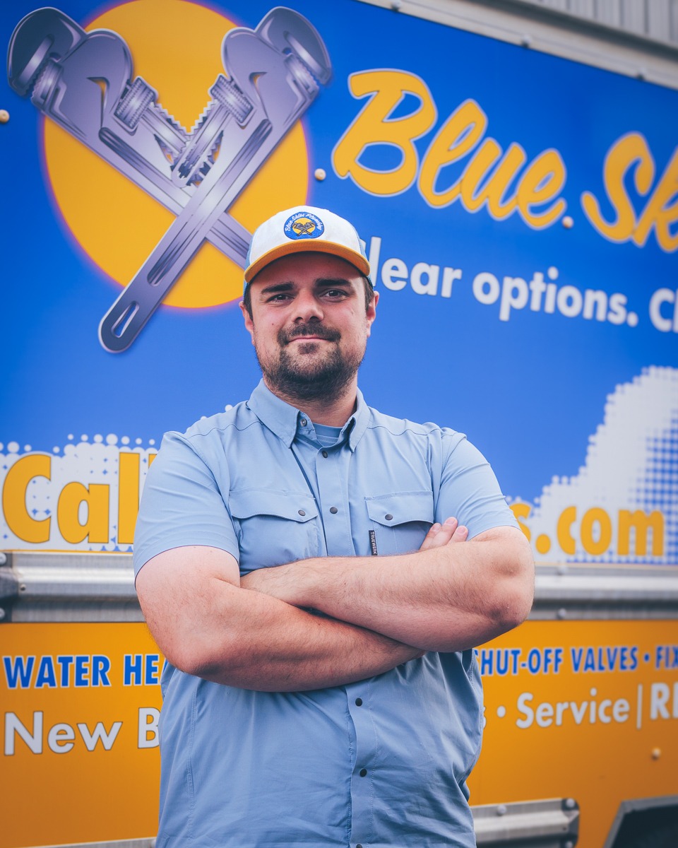Blue Skies Plumbing service technician Flavius in front of the company truck in Spokane